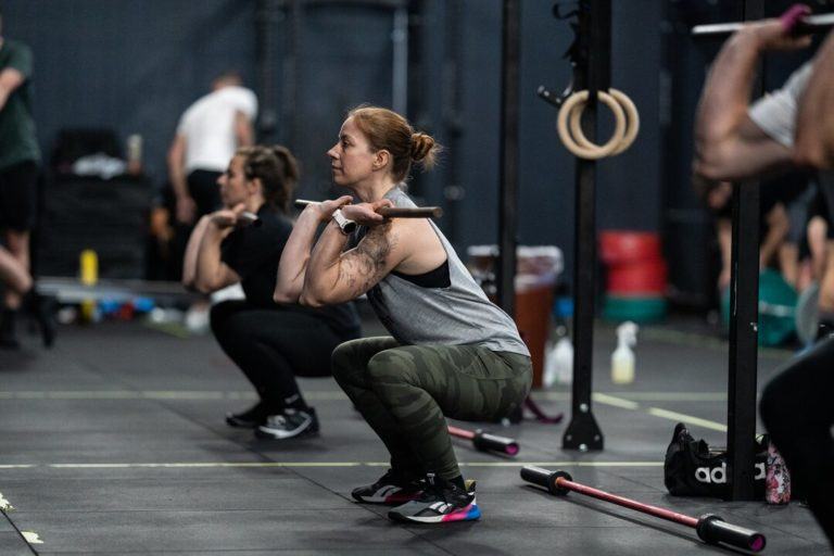 An athlete performing a CrossFit movement, illustrating a first CrossFit class