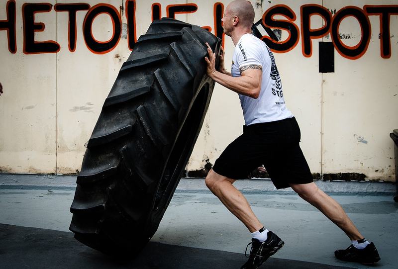 Athlete tyre flipping during a CrossFit workout